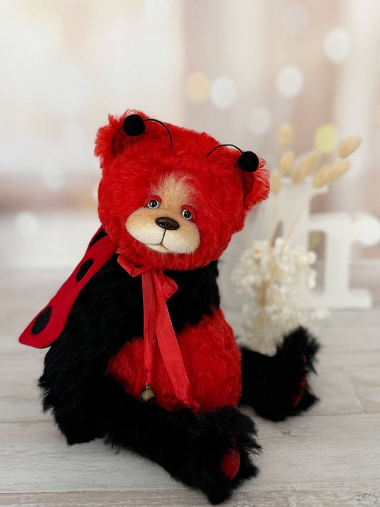 Scarlet Ladybug Deluxe artist bear in red and black mohair with tiny antennae, side view