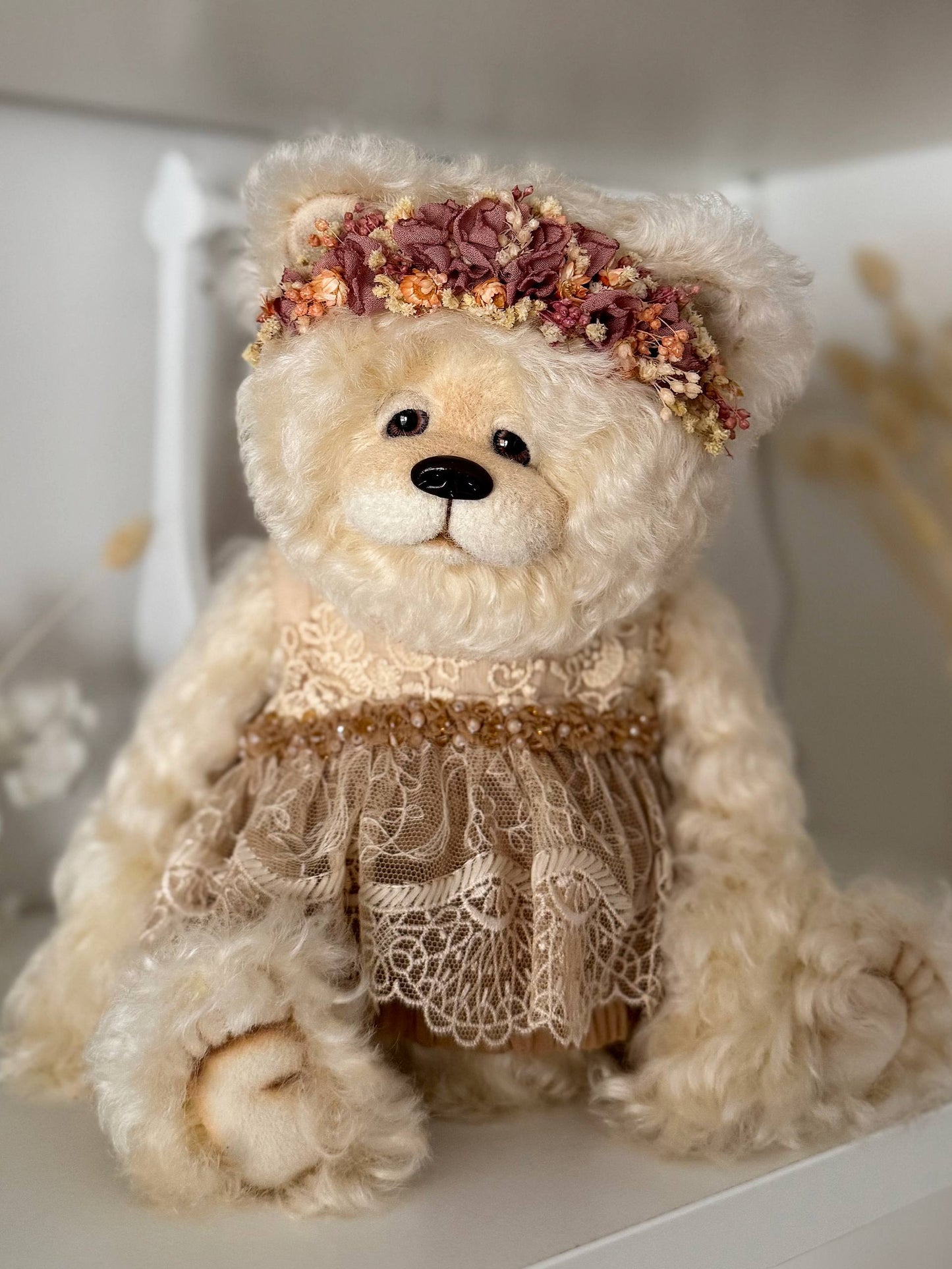 Side view of handmade OOAK teddy bear Olivia in ivory mohair and lace dress with glass beads