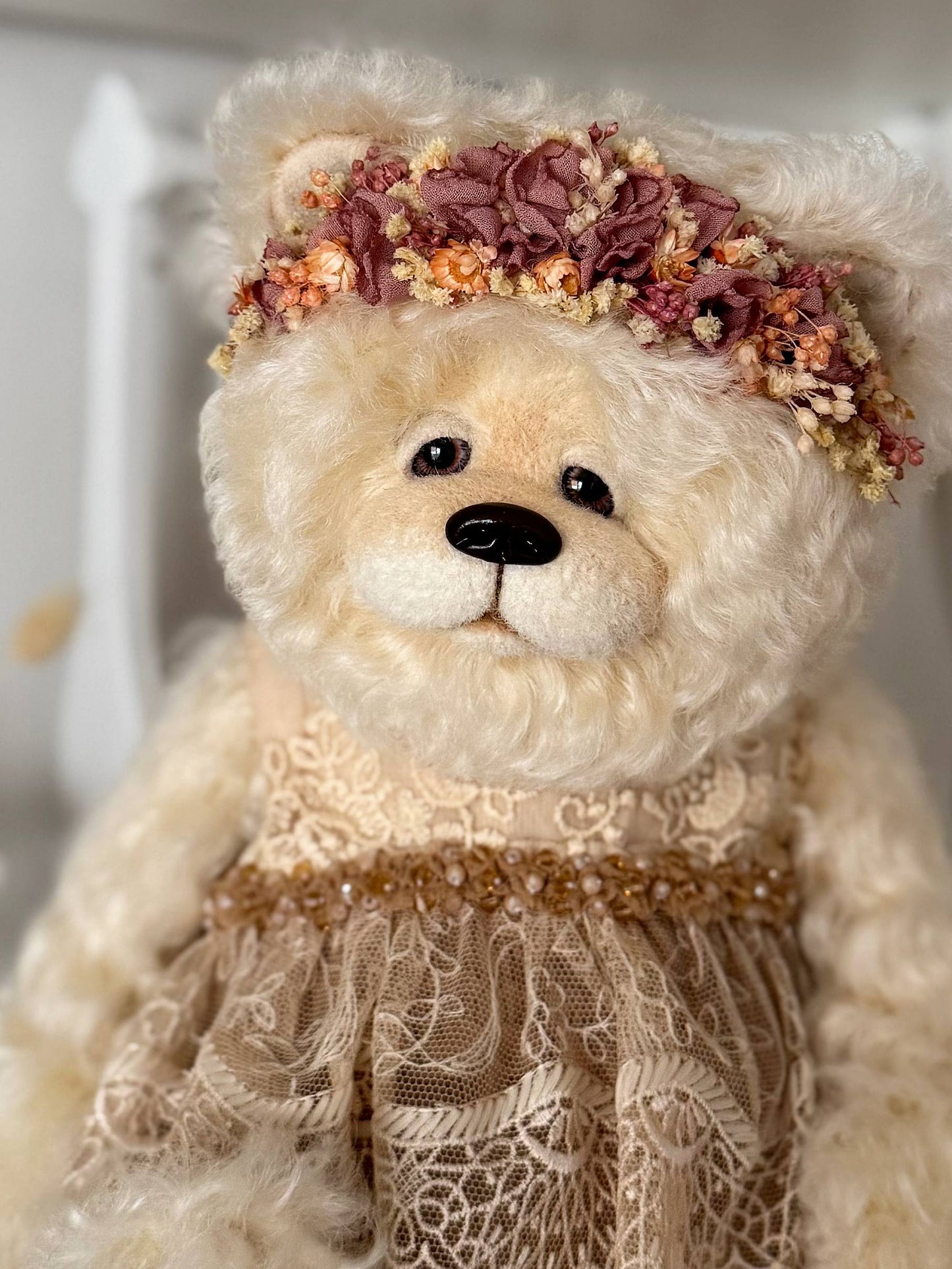 Close-up portrait of handmade mohair bear Olivia with glass eyes, hand-sculpted nose and oil shading