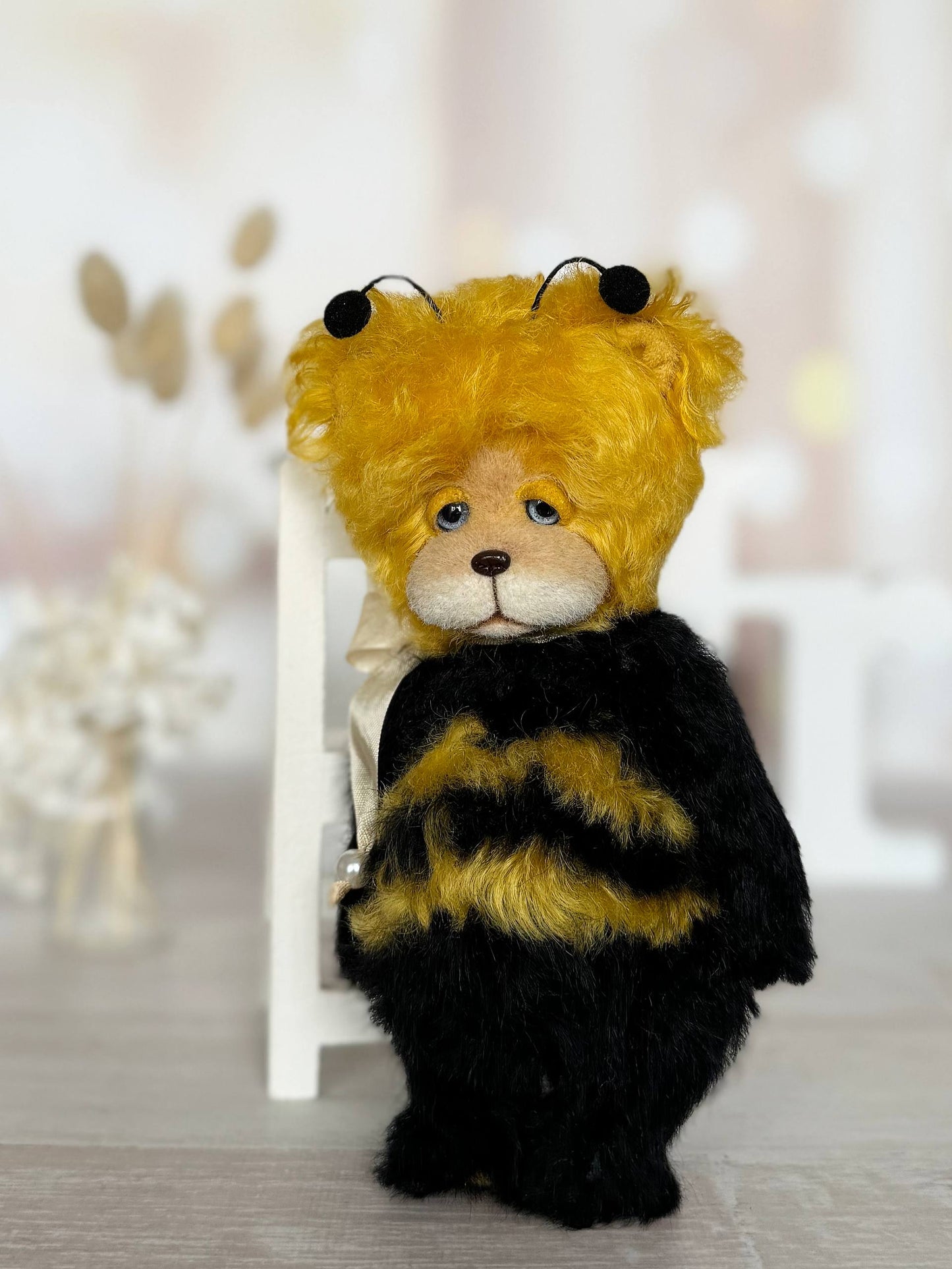 Close-up of Little Sunny Bee teddy bear face with blue glass eyes and hand-sculpted nose