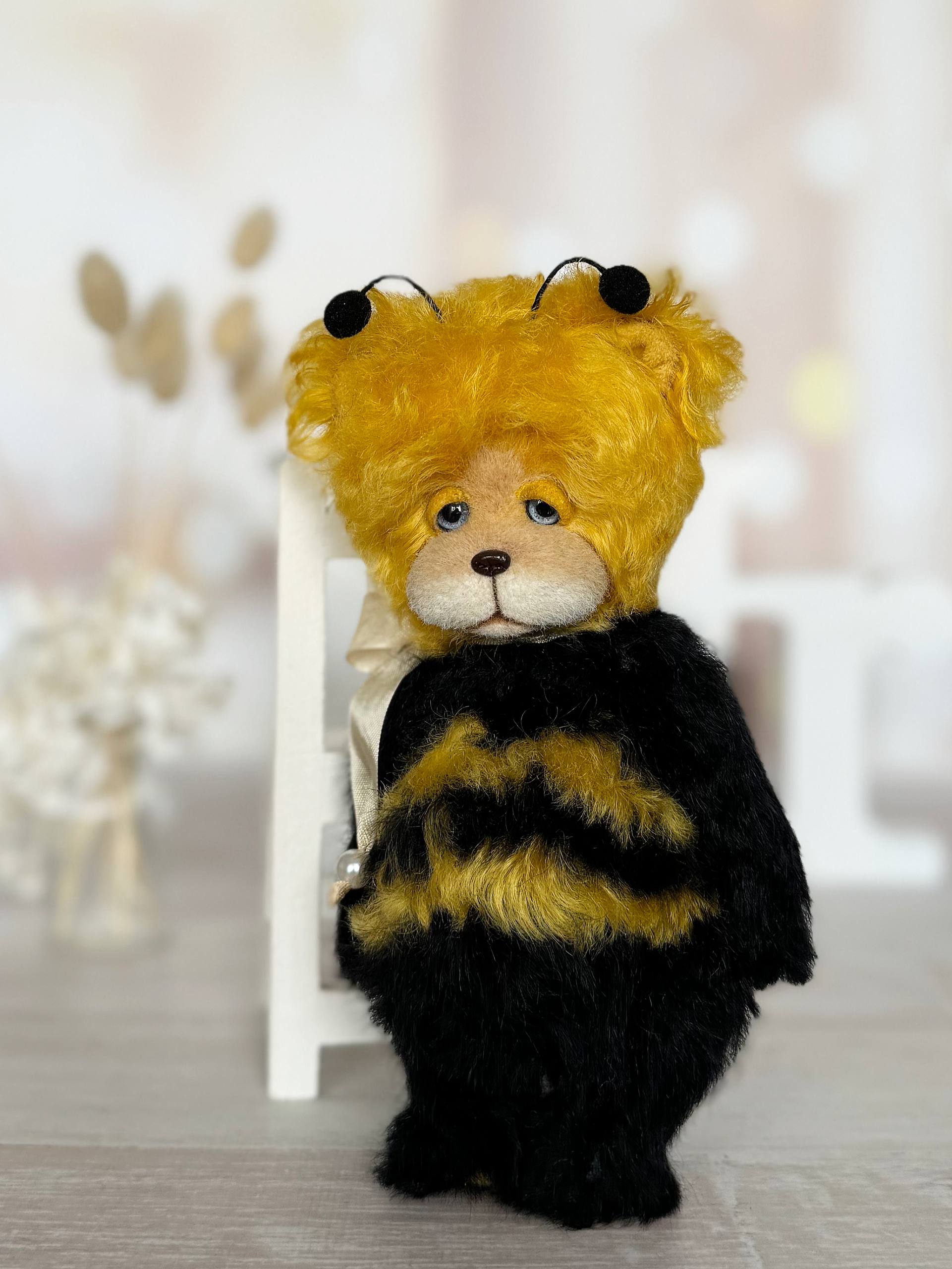 Close-up of Little Sunny Bee teddy bear face with blue glass eyes and hand-sculpted nose