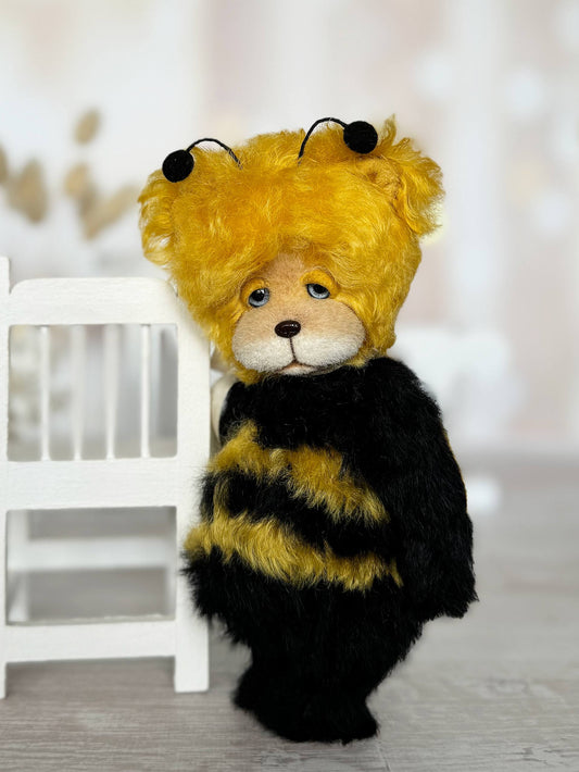 Little Sunny Bee artist bear with golden fur accents and yellow wings, side view