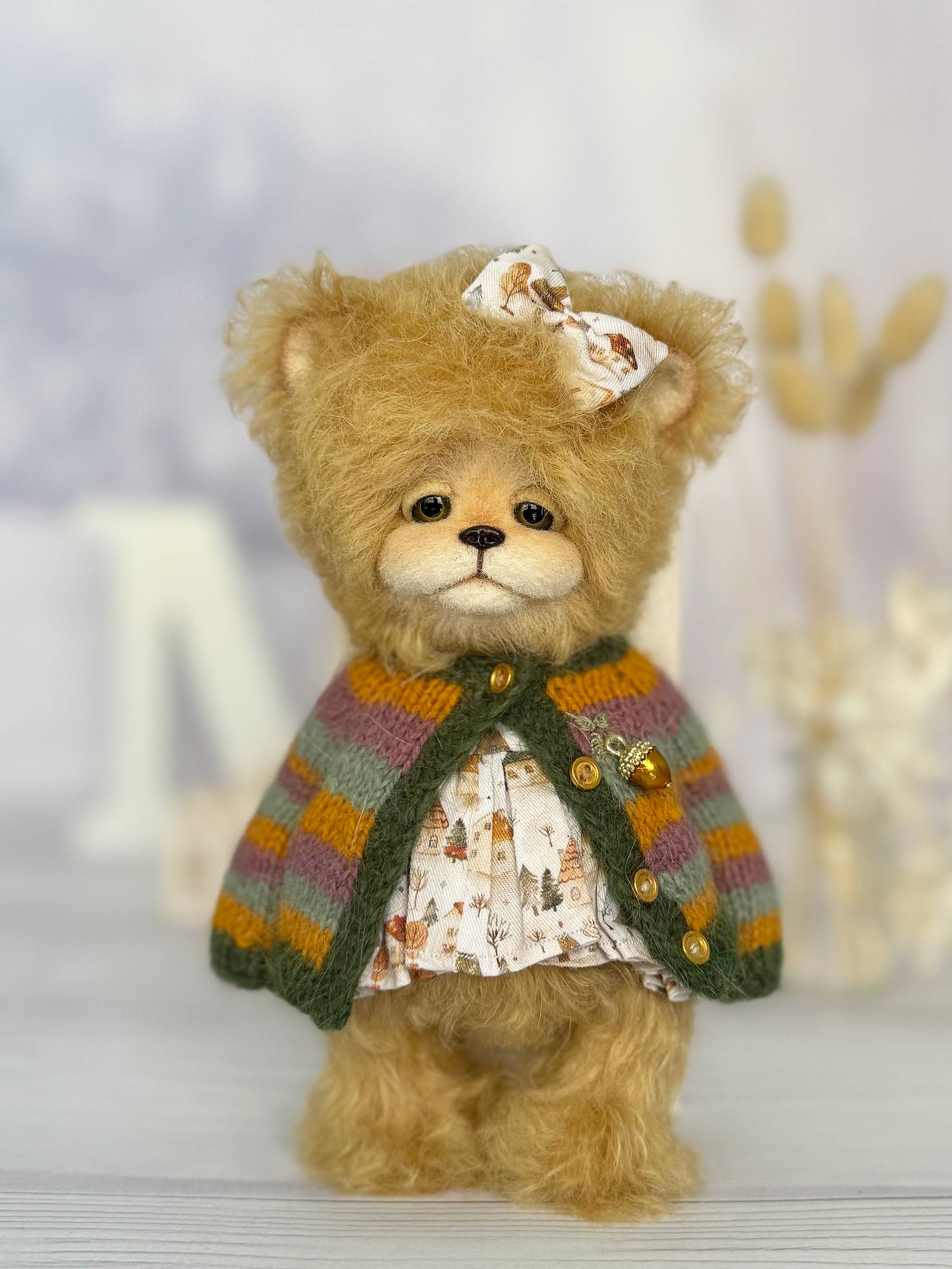 Close-up of handmade teddy bear Elsa showing detailed craftsmanship and pastel toning